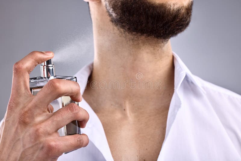 unrecognizable man spraying perf