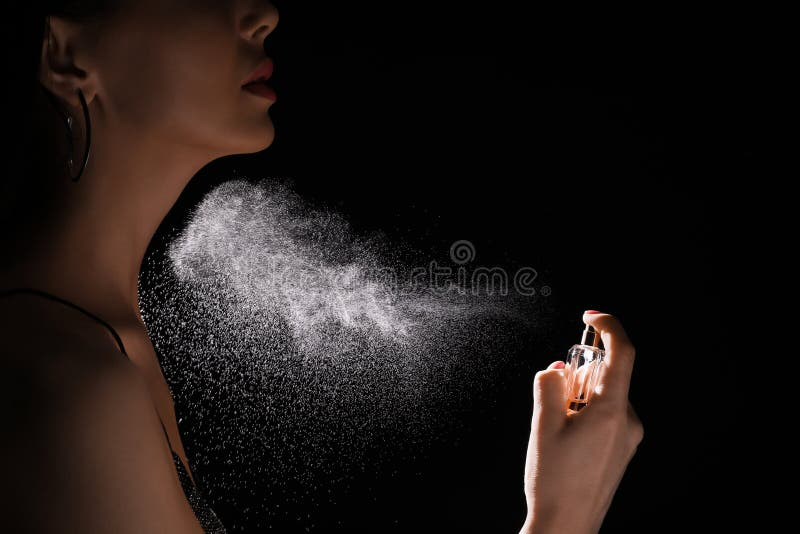 woman spraying luxury perfume bl